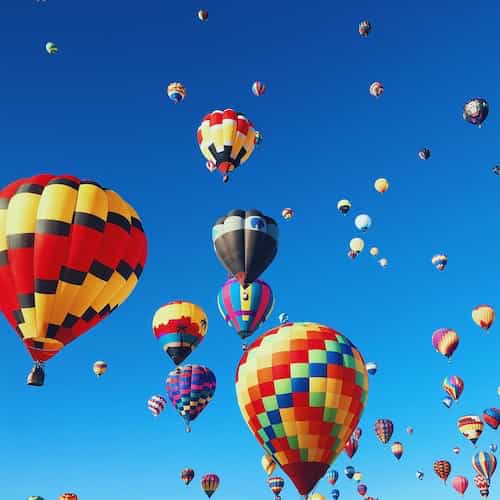 Hot-air balloons of all shapes, colors and sizes in the sky